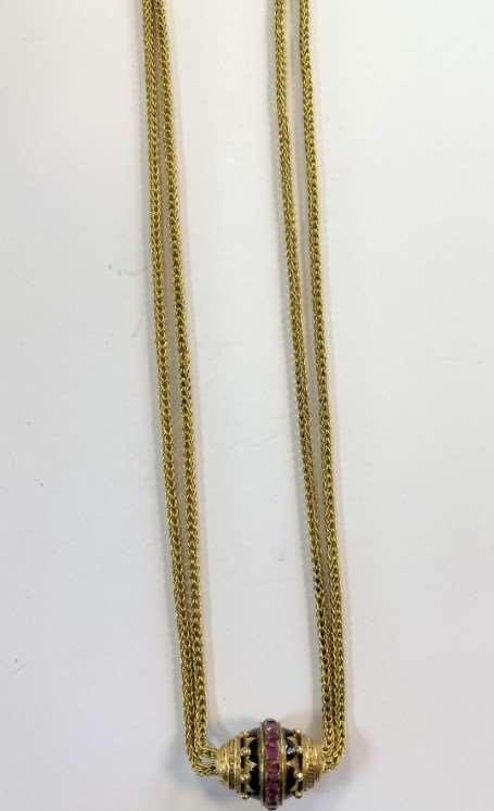 Long guard chain with ruby and enamel slider, foxtail link chain doubled up and suspending a carved and black enamelled barrel shaped slider